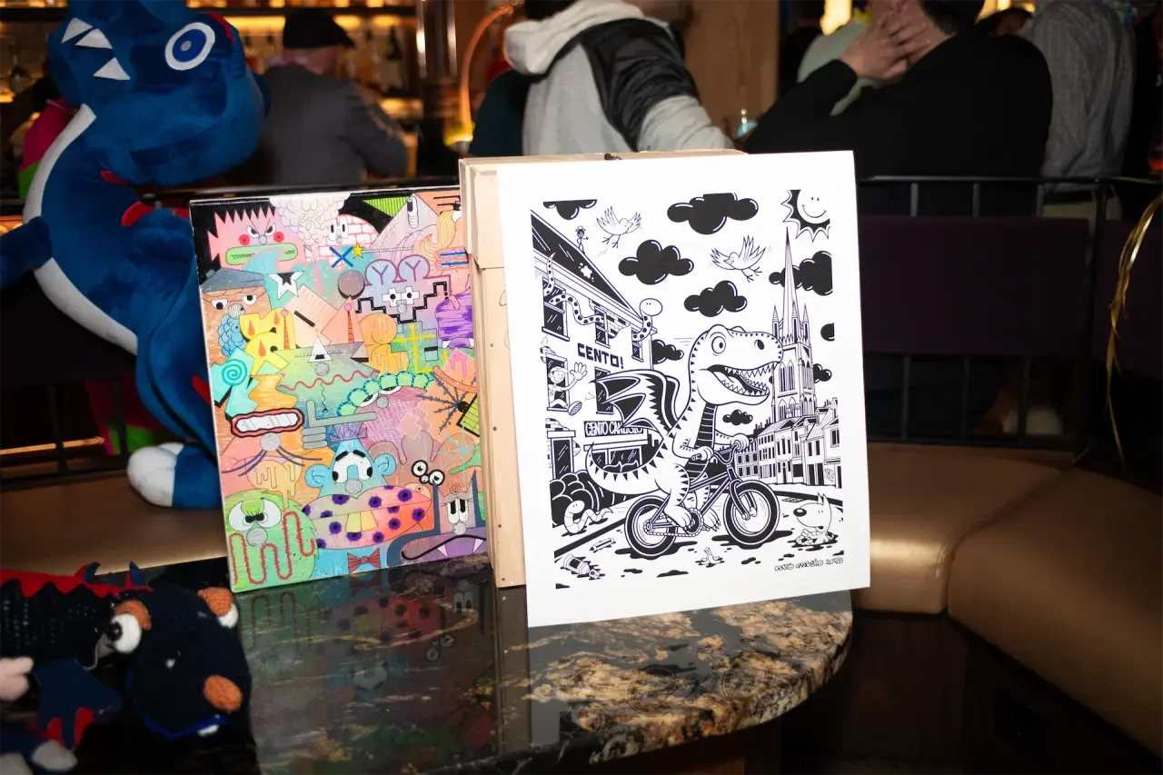 Colorful mixed-media artwork by Cento displayed beside a black-and-white illustrated piece by Smole at the Epic Party.
