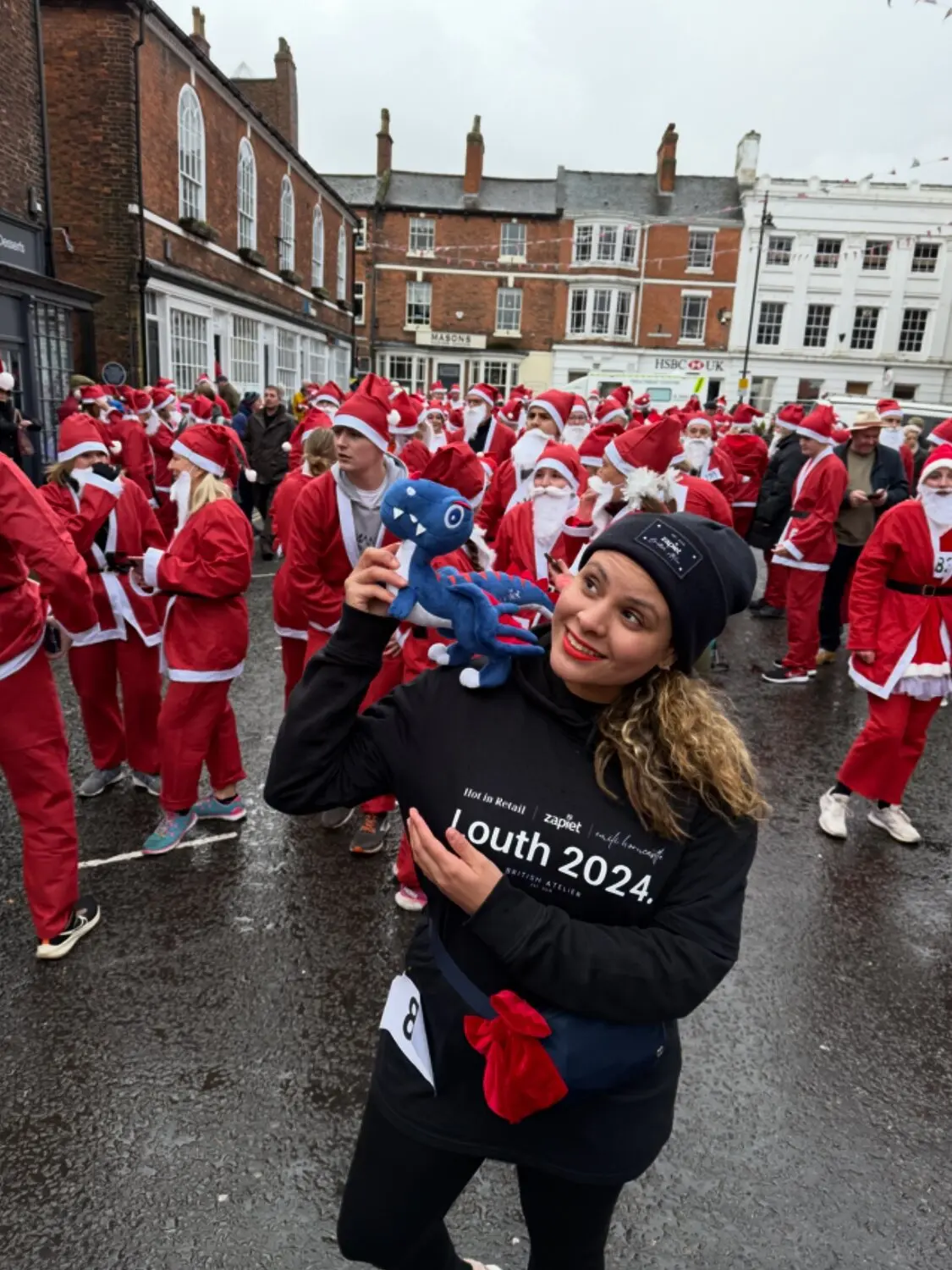 Emili, casually photobombed by the entire Louth Santa Run. 🎅